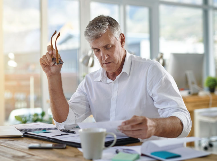 Older man looking at his financial records