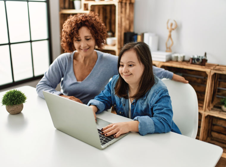 Adult and girl researching on computer