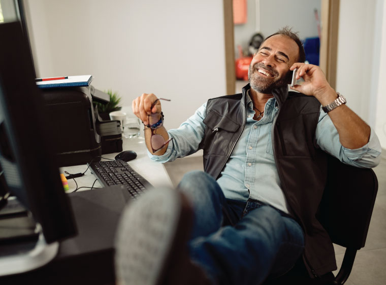 man in office on phone